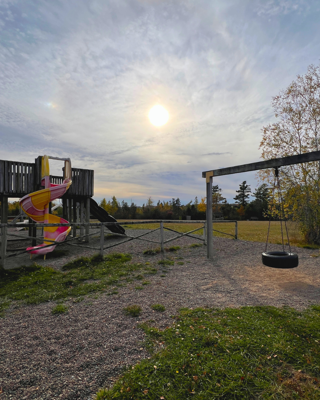 The tire swing and spiral slide on the playground